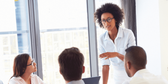 Person leading a meeting in an office